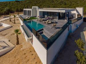 an aerial view of a house with a swimming pool at Villa Porta Novalja in Novalja