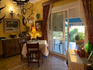 a dining room with a table and a sliding glass door at La Finca Mercedes in La Iruela