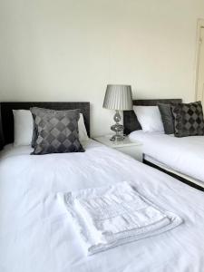 a bedroom with two beds with a blanket on it at Immaculate 3-Bed Travel nest unavailable in Manchester