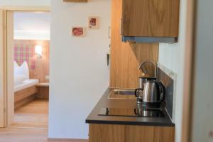 a kitchen with a tea kettle on a stove at Landhaus Sunseitn in Ramsau am Dachstein