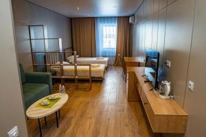 a room with a living room with a couch and a table at Fly Apartment in Prigorodnyy