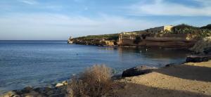 a view of a body of water with a castle at Sunlight house in Marsaskala
