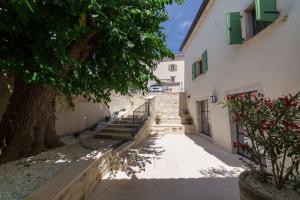 a building with stairs and a tree next to it at Villa Santina by Briskva in Višnjan +37 photos