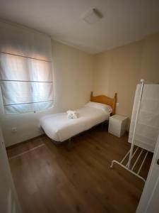 a small room with a bed and a window at APARTAMENTO NEVADA in Pinos Genil
