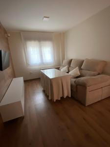 a living room with a couch and a table at APARTAMENTO NEVADA in Pinos Genil