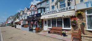 a street with a bench in front of a building at Blackpool Lodge in Blackpool