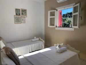 Postel nebo postele na pokoji v ubytování Pandora Villa