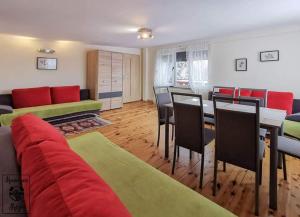 a living room with a couch and a table and chairs at Koniecznie Róża in Karpacz +8 photos