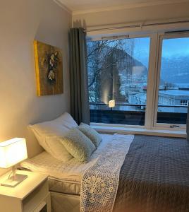 a bedroom with a bed and a large window at Fagre Stryn Feriehus in Stryn