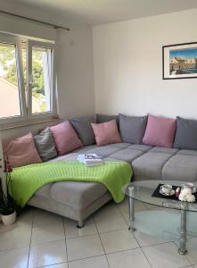 a living room with a couch and a table at Apartman Jadro in Solin