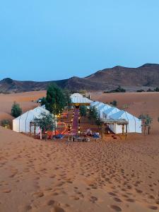 a tent in the desert in the sand at Khamlia Desert Luxury Camp in Merzouga