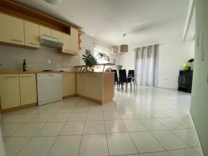 an empty kitchen and dining area of a apartment at Apartman Jadro in Solin