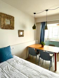 a bedroom with a bed and a table and chairs at Casa Del Mar in Costa de Antigua