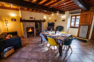 a living room with a table and a fireplace at Gîte de benque in Benqué