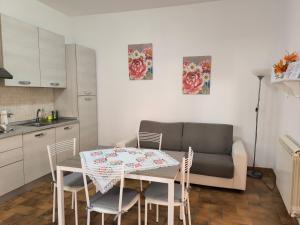 a kitchen and a table with chairs and a couch at La Corte in Morlupo