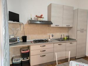 a small kitchen with a sink and a stove at La Corte in Morlupo +6 photos