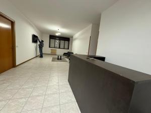 a man is standing in a hallway in a building at Volturno House2 in Rome