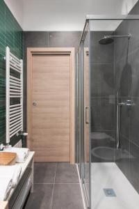 a bathroom with a shower and a glass door at Meraki Family House in Naples
