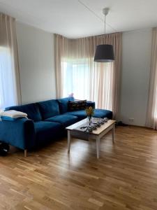 a living room with a blue couch and a coffee table at Cozy one bedroom apartment in Tartu