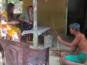 a group of people sitting outside of a house at Villa Sea View in Galle