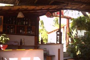 a bar with a lot of bottles of alcohol at Estresse Zero in Atins