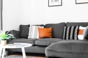 a living room with a gray couch with pillows at City Centre - Two Bedroom Apartment - Juliet Balcony - Secure Parking - WIFI - Smart TV - Top Rated -33S in Birmingham