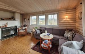 a living room with a couch and a table at Beautiful Home In Vringsfoss With House A Panoramic View in Maurset