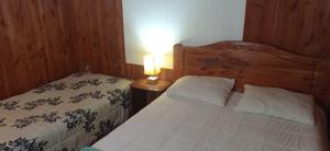 Postel nebo postele na pokoji v ubytování HOSTAL CARHUELLO