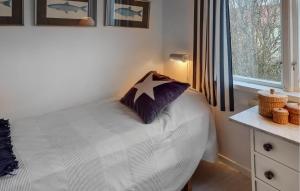 a bedroom with a bed with a star pillow on it at Awesome Home In Hn With Kitchen in Hönö
