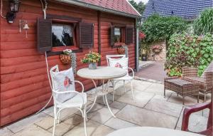 una casa con patio con mesa y sillas en 1 Bedroom Gorgeous Home In Mllrose, en Müllrose