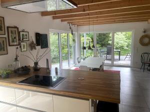 a kitchen with a wooden counter top and a table at Quiet, Central House (150sqm) with Garden & Sauna in Norderstedt