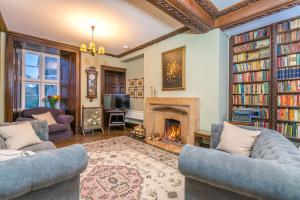 a living room with two couches and a fireplace at Gors-Y-Gedol in Dyffryn