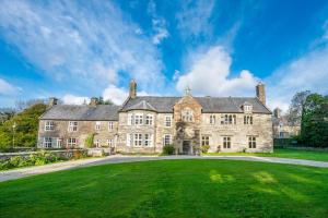 an old stone house with a large grassy yard at Gors-Y-Gedol in Dyffryn