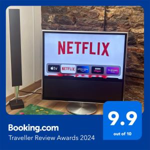 a television with a netflix sign on the screen at Luxury 1 Bedroom Duplex with Free Parking in Plymouth