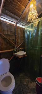 a bathroom with a toilet and a sink at Bice Camp Darocotan in El Nido