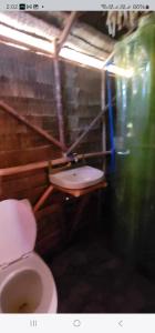 a bathroom with a white toilet in a room at Bice Camp Darocotan in El Nido