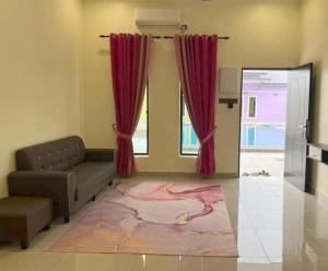 uma sala de estar com um sofá e cortinas vermelhas em D Sayang Homestay Parit Buntar MUSLIM SAHAJA em Parit Buntar