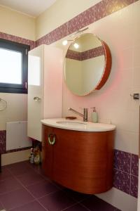 a bathroom with a sink and a mirror at Cozy home in Ioannina