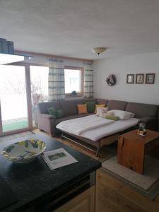 a living room with a couch and a table at Chalet Bergheimat in Wagrain