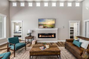 a living room with a couch and a fireplace at Maynard Dixon: Desert Luxury & Stargazer's Oasis in Kanab