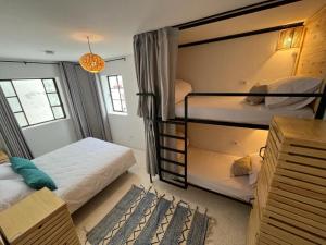 a bedroom with two bunk beds and a room with at Socco Hostel in Tangier