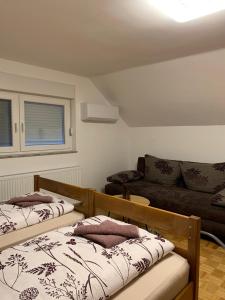 a living room with two beds and a couch at Prenoćište Šimić in Slavonski Brod