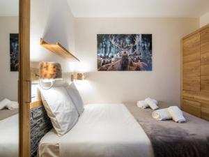 a bedroom with a bed with a picture on the wall at Appartement Val Thorens, 2 pièces, 4 personnes - FR-1-640-51 in Val Thorens