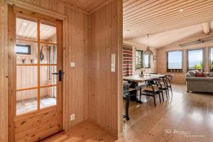 a dining room and living room with a table and chairs at Ål Skisenter - Cabin with panoramic view for 8 guests in Holo