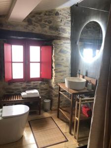 a bathroom with a white tub and a sink at Casa dos Veados in Ladeiras