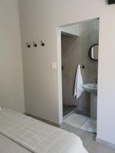 a white bathroom with a sink and a toilet at Stay@Opstal in Pretoria