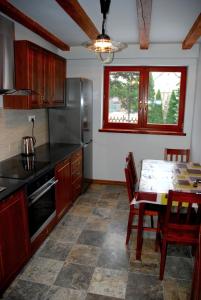 a kitchen with a table and a dining room at Hortensja in Iława +20 photos