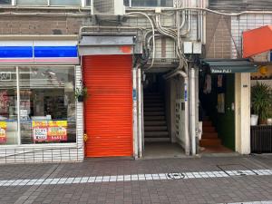 a red door on the side of a building at Roxy inn in Oita