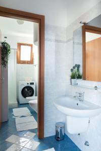 a bathroom with a sink and a toilet at Residence Yellow in Rimini