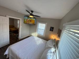 um quarto com uma cama e uma ventoinha de tecto em Family Friendly Fun Dogtown Cottage Near The Zoo em Benton